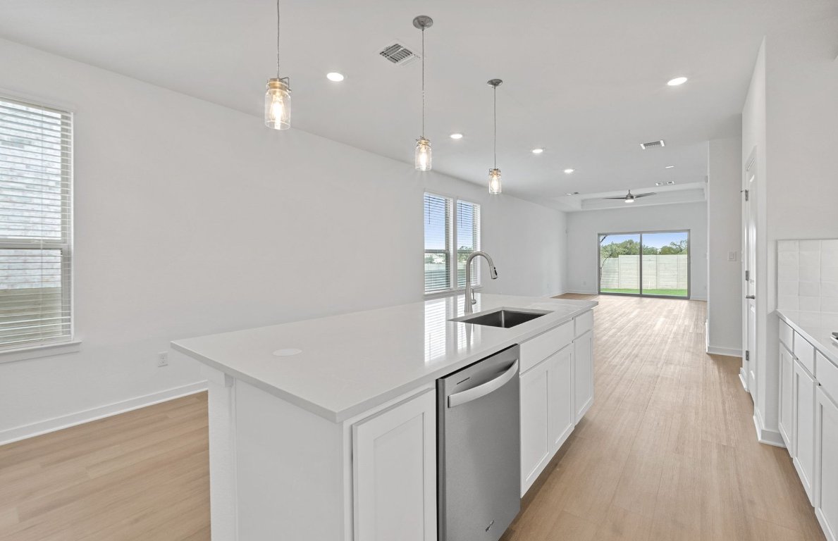 1700 Spg Mountain Cove Georgetown, TX 78628 - Photo 10 of 40 a kitchen with granite countertop a sink and a stove top oven
