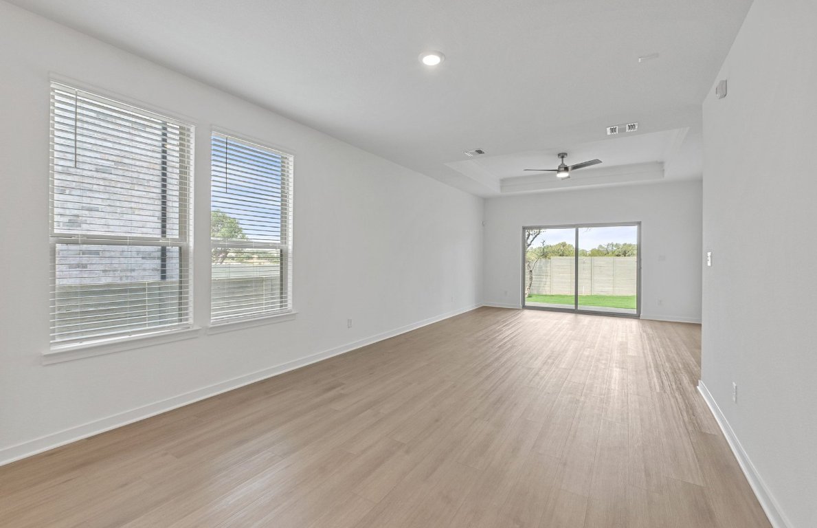 1700 Spg Mountain Cove Georgetown, TX 78628 - Photo 12 of 40 a view of an empty room with wooden floor and a window