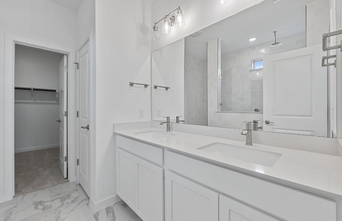 1700 Spg Mountain Cove Georgetown, TX 78628 - Photo 17 of 40 a bathroom with a sink and a mirror