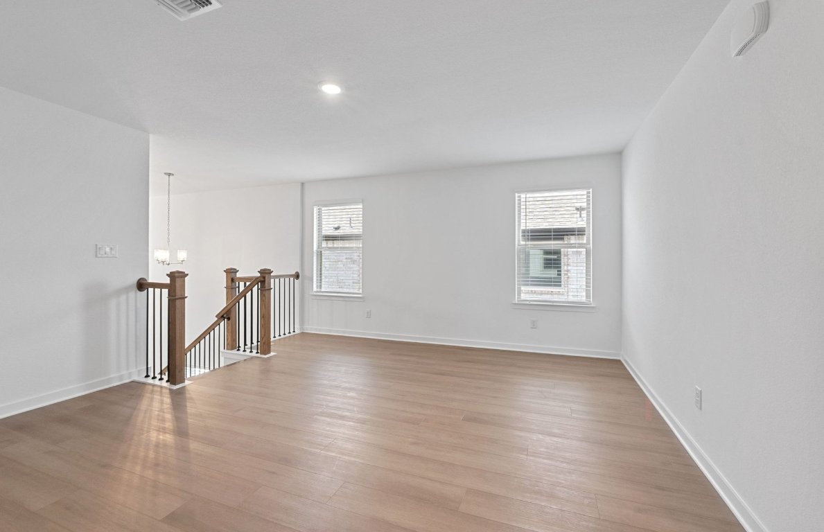 1700 Spg Mountain Cove Georgetown, TX 78628 - Photo 24 of 40 an empty room with wooden floor and a window