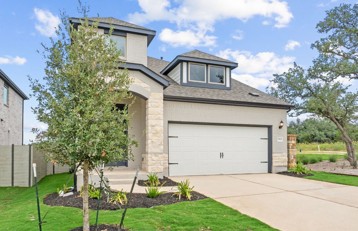 1700 Spg Mountain Cove Georgetown, TX 78628 - Photo 3 of 40 a front view of a house with garden