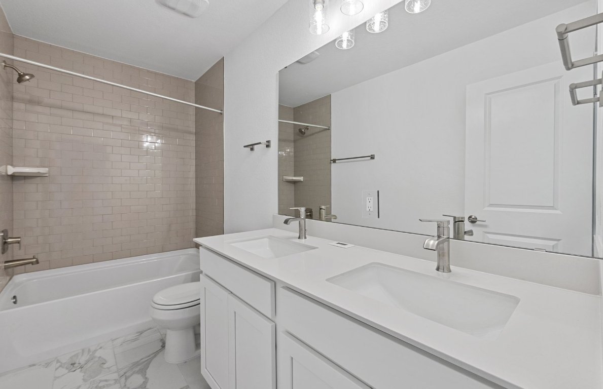 1700 Spg Mountain Cove Georgetown, TX 78628 - Photo 30 of 40 a bathroom with a sink a toilet and shower