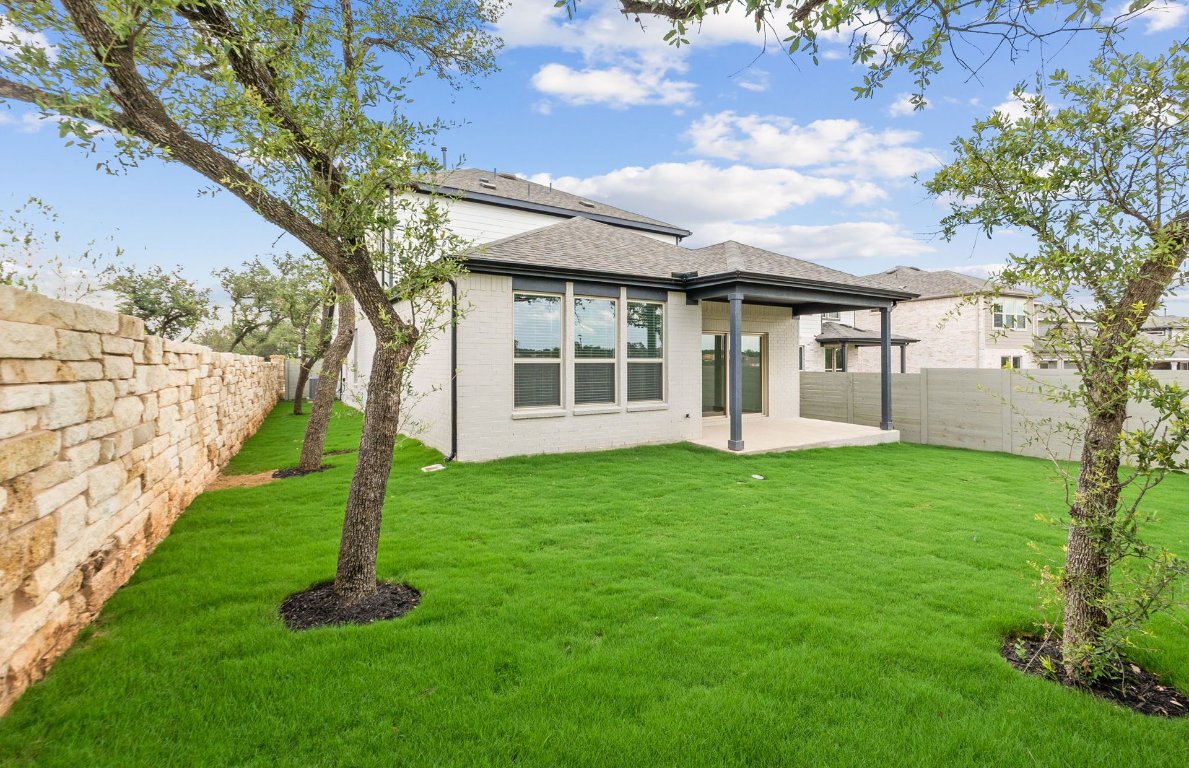1700 Spg Mountain Cove Georgetown, TX 78628 - Photo 35 of 40 a view of a house with backyard and a tree