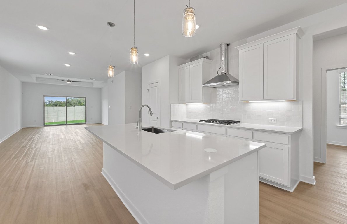 1700 Spg Mountain Cove Georgetown, TX 78628 - Photo 7 of 40 a kitchen with kitchen island a sink appliances and cabinets