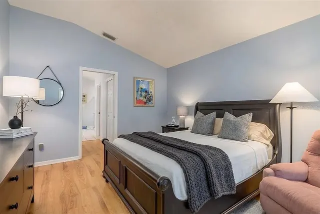 a bedroom with a bed and a lamp