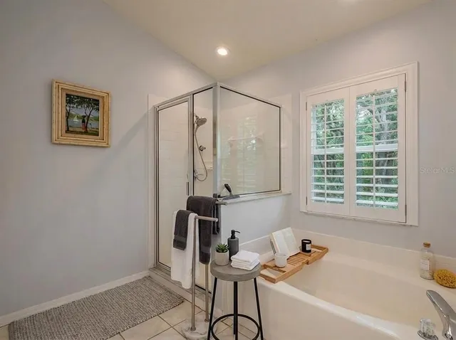 a bathroom with a bathtub and a window