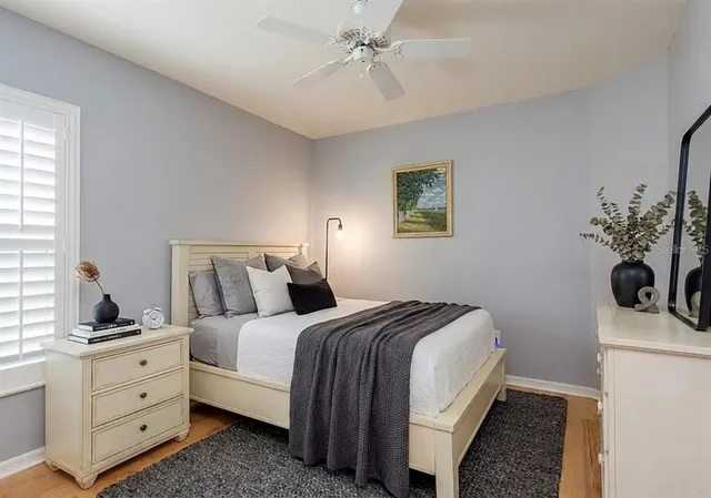 a bedroom with a bed and a potted plant