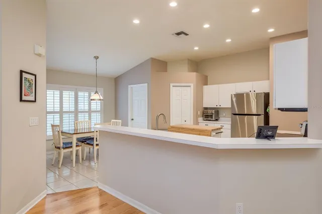 a kitchen with stainless steel appliances with kitchen island