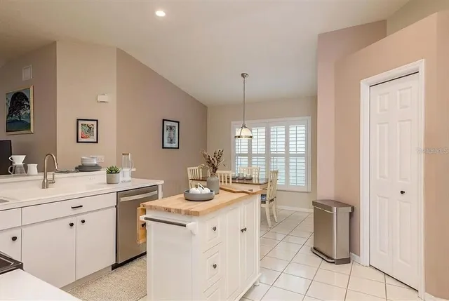 a room with a sink cabinets and appliances