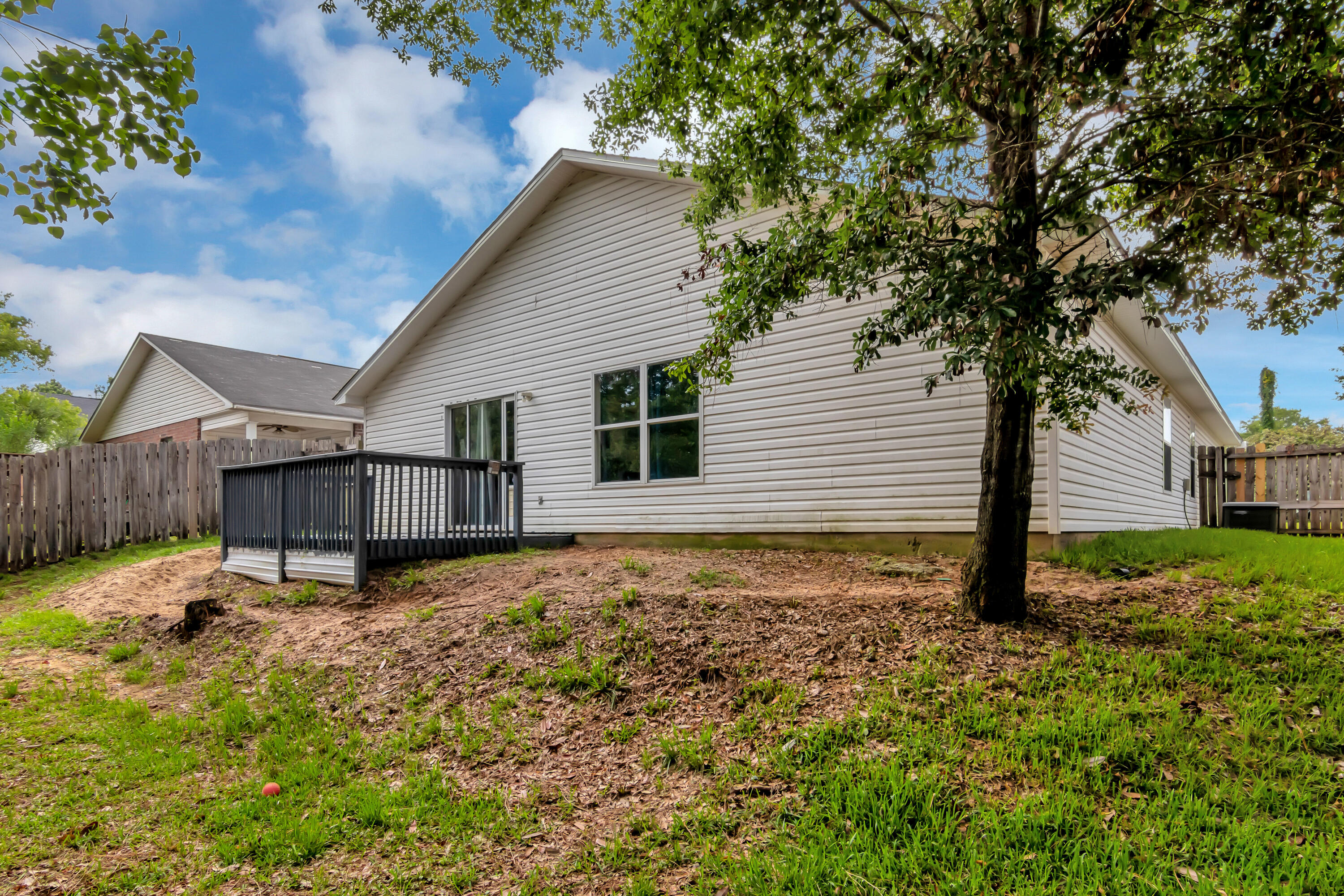 270 Limestone Circle Crestview, FL 32539 - Photo 33 of 35 a backyard of a house with wooden fence and large trees