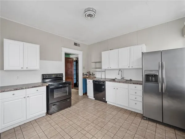 a kitchen with cabinets stainless steel appliances and a counter space