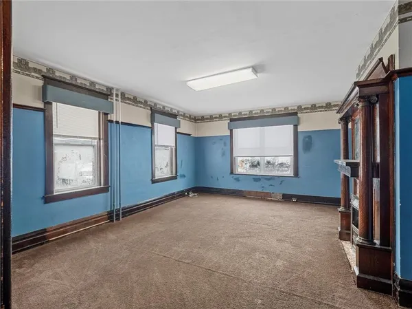 an empty room with fireplace