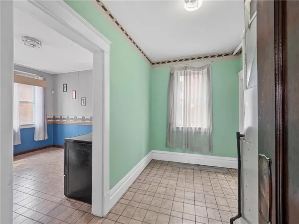 a view of a hallway with furniture and a window