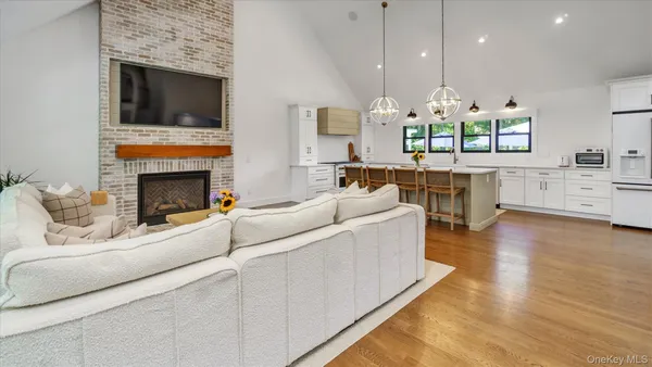 a living room with furniture fireplace and flat screen tv