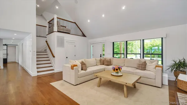 a living room with furniture and a wooden floor