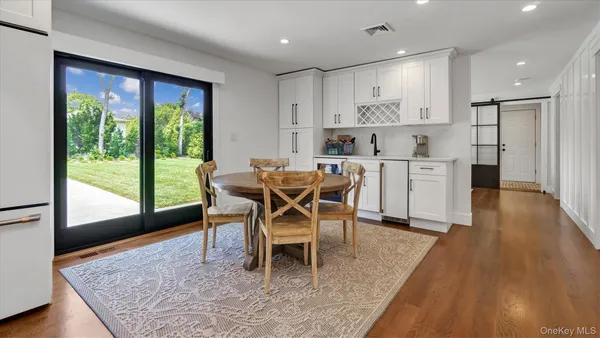 a dining room with furniture and wooden floor