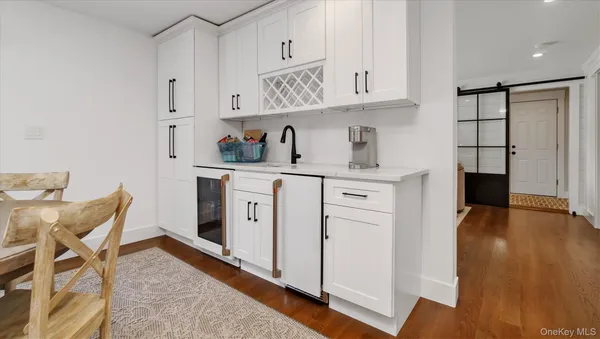 a view of cabinets a wooden floor and a window in a kitchen