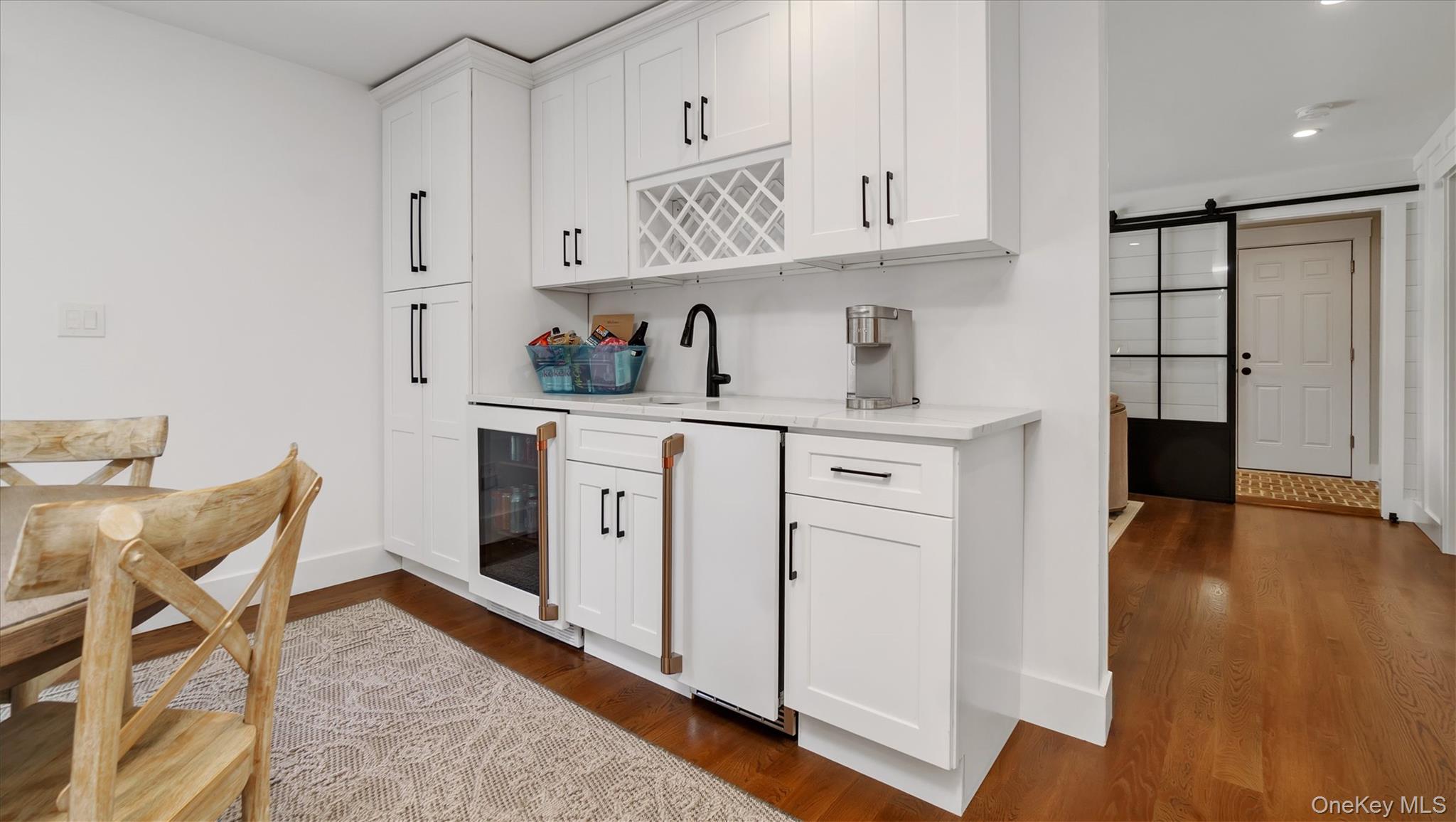 99 Beach Road Westhampton Beach, NY 11978 - Photo 14 of 37 a view of cabinets a wooden floor and a window in a kitchen