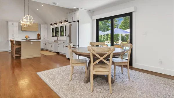 a view of a dining room with furniture and a large window