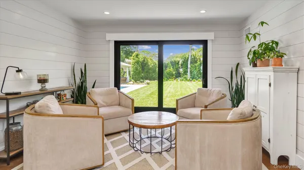 a living room with furniture a table and a large window