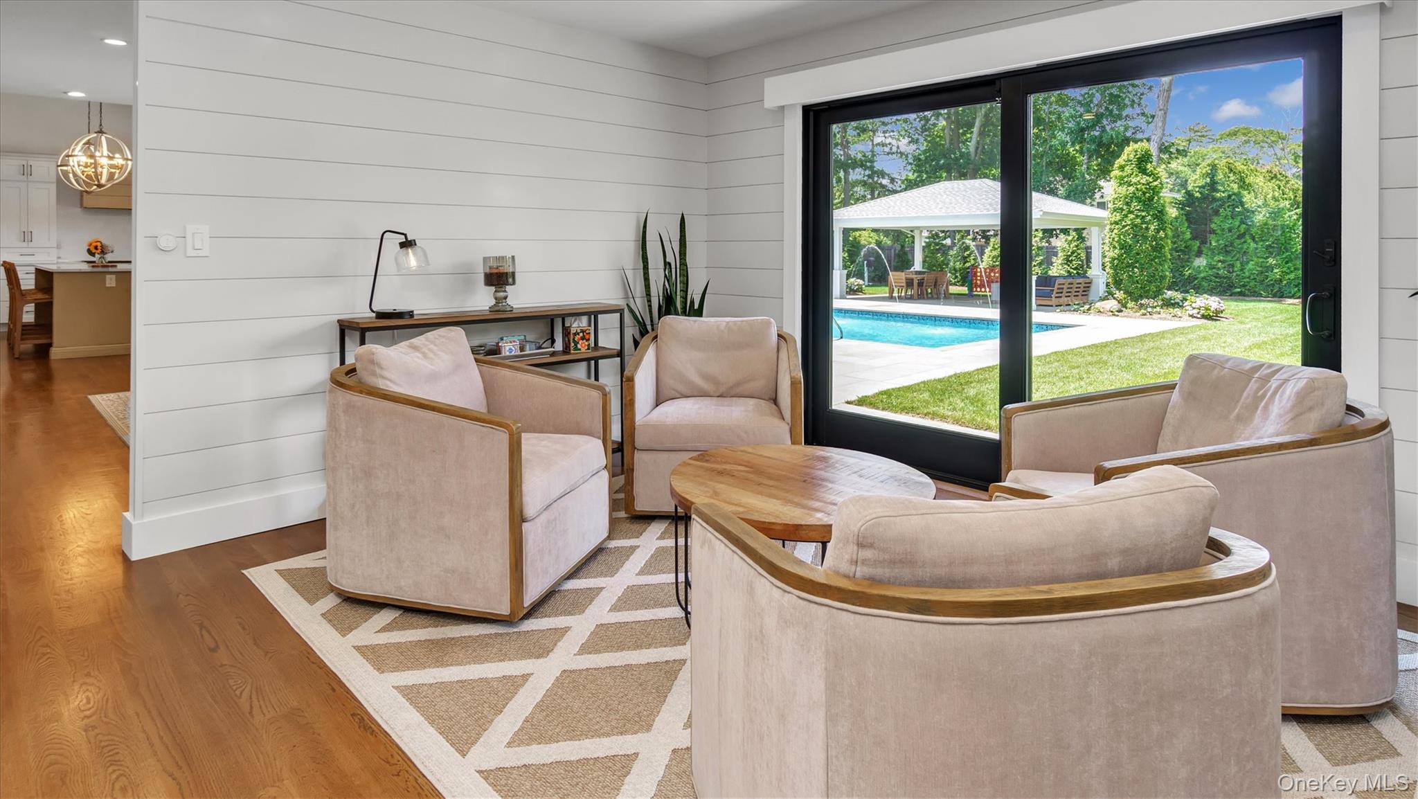 99 Beach Road Westhampton Beach, NY 11978 - Photo 18 of 37 a living room with furniture and a floor to ceiling window