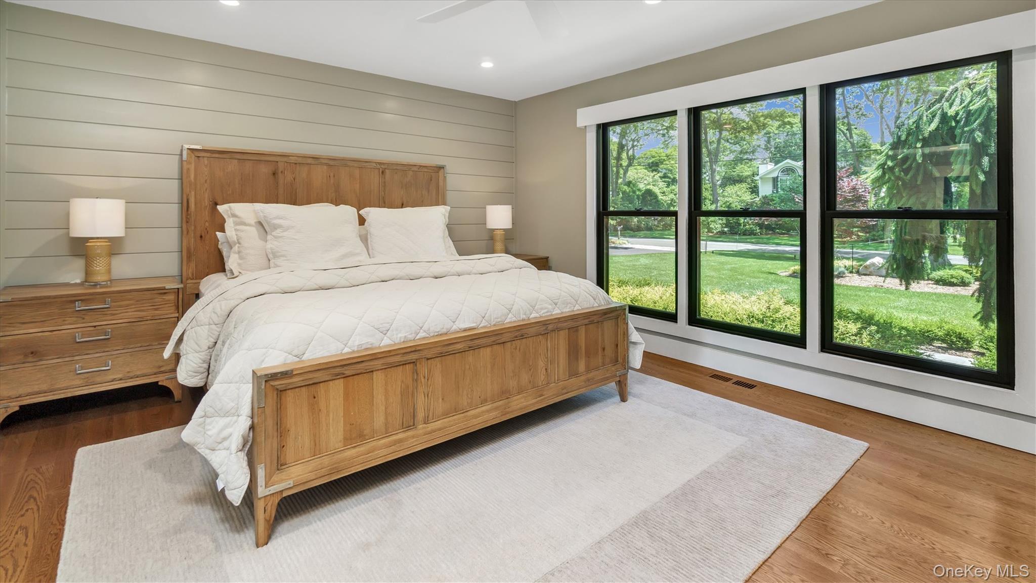 99 Beach Road Westhampton Beach, NY 11978 - Photo 20 of 37 a spacious bedroom with a bed lamp and large window
