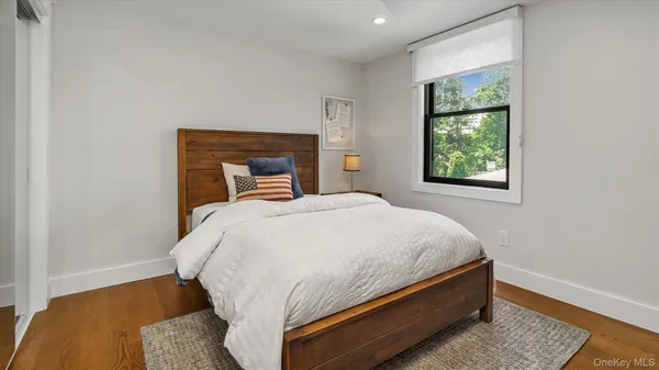 a bed sitting in a bedroom next to a window