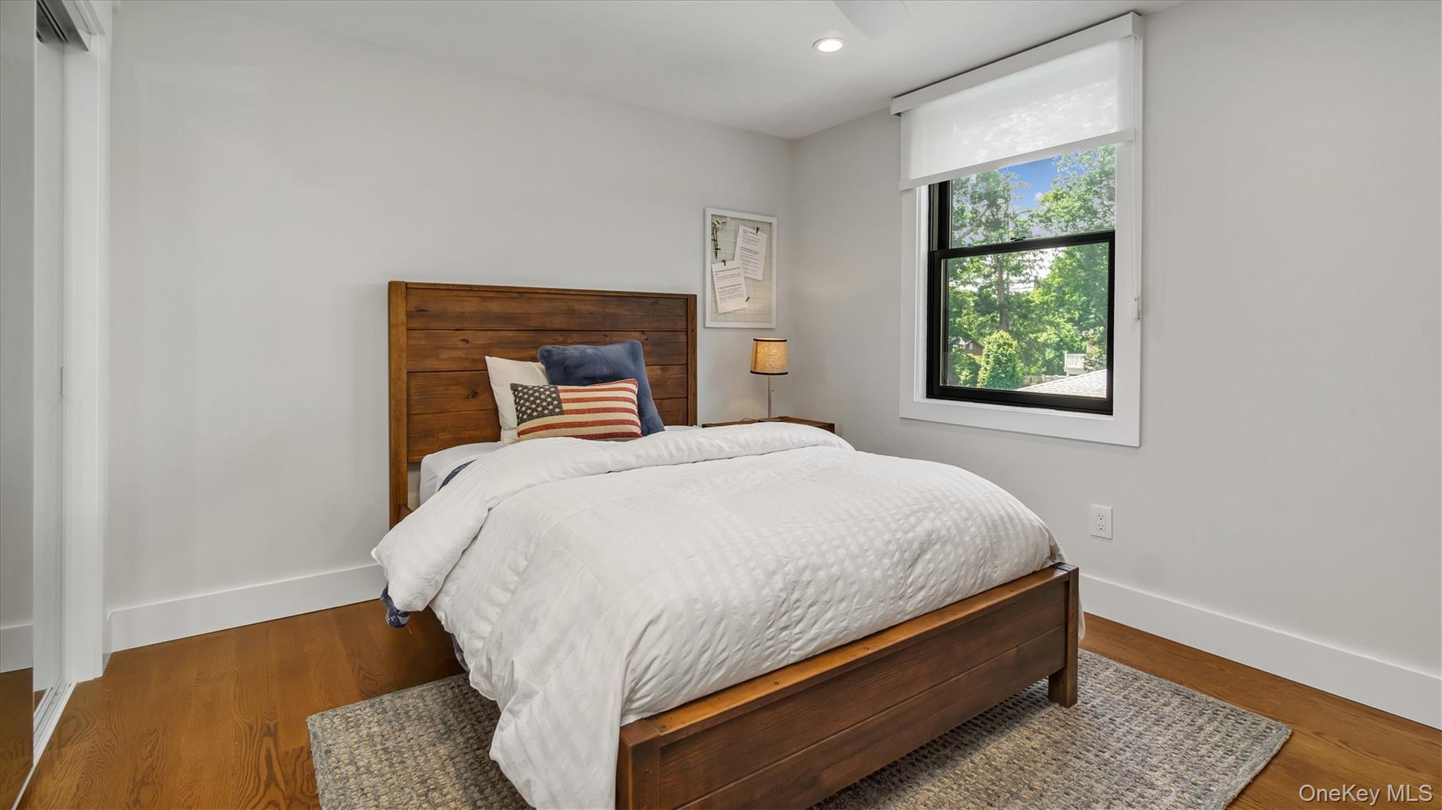 99 Beach Road Westhampton Beach, NY 11978 - Photo 26 of 37 a bed sitting in a bedroom next to a window