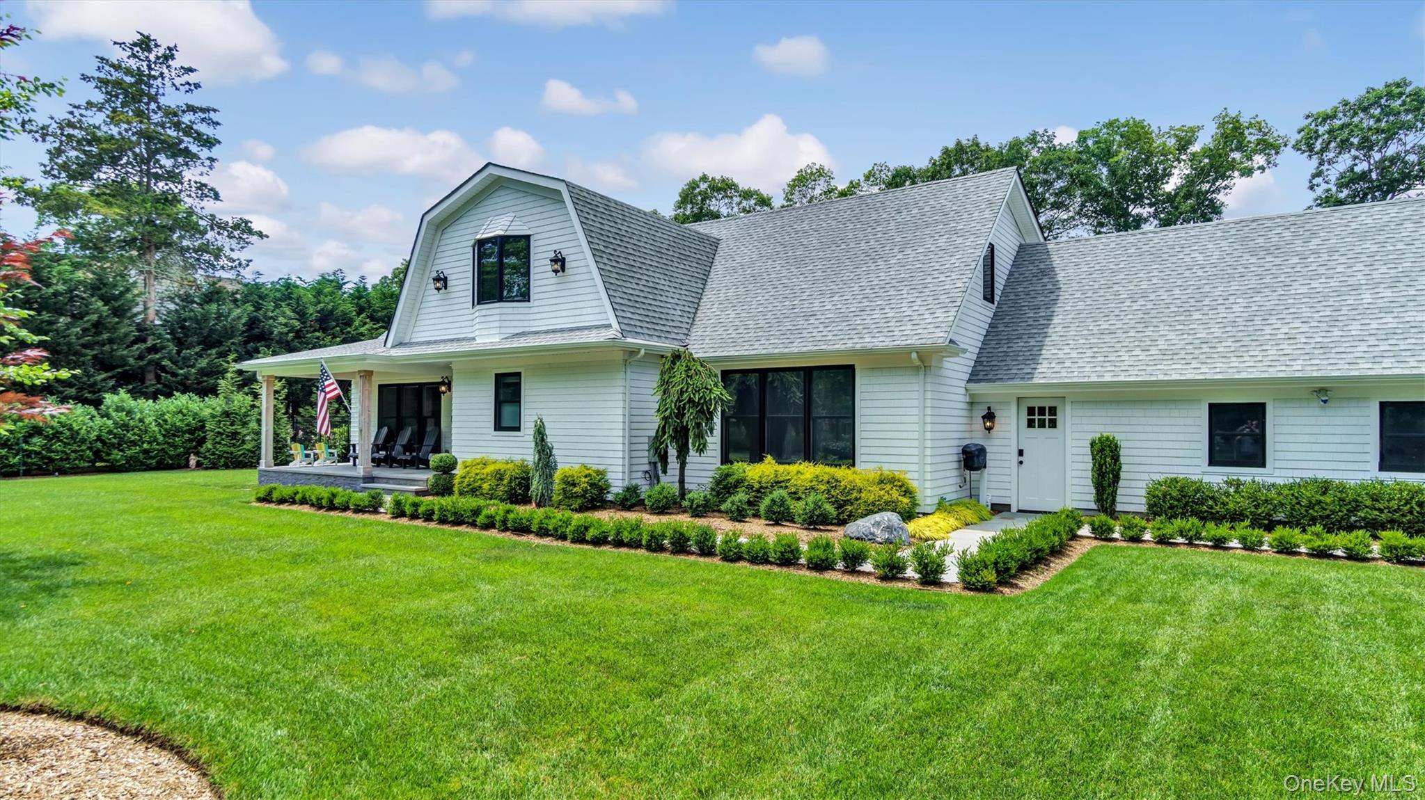 99 Beach Road Westhampton Beach, NY 11978 - Photo 3 of 37 a front view of a house with a yard and porch