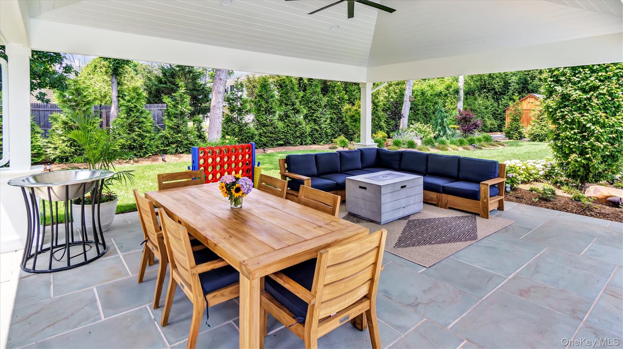 99 Beach Road Westhampton Beach, NY 11978 - Photo 34 of 37 a outdoor dining space with furniture and garden view