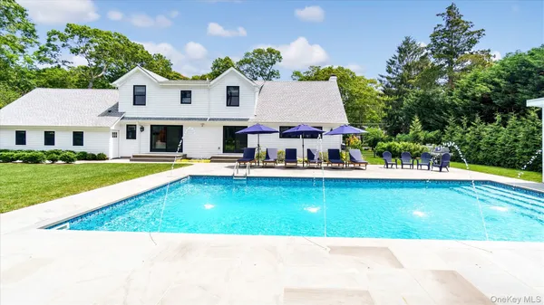 a view of a house with a yard porch and sitting area