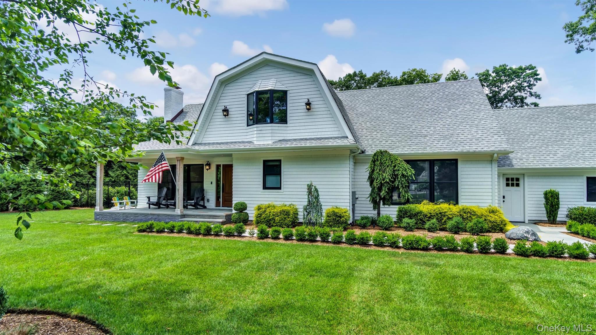 99 Beach Road Westhampton Beach, NY 11978 - Photo 4 of 37 a front view of a house with a yard
