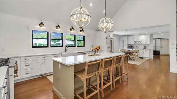 a large kitchen with a table and chairs