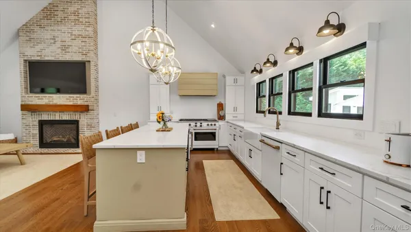 a large kitchen with cabinets a sink and a stove