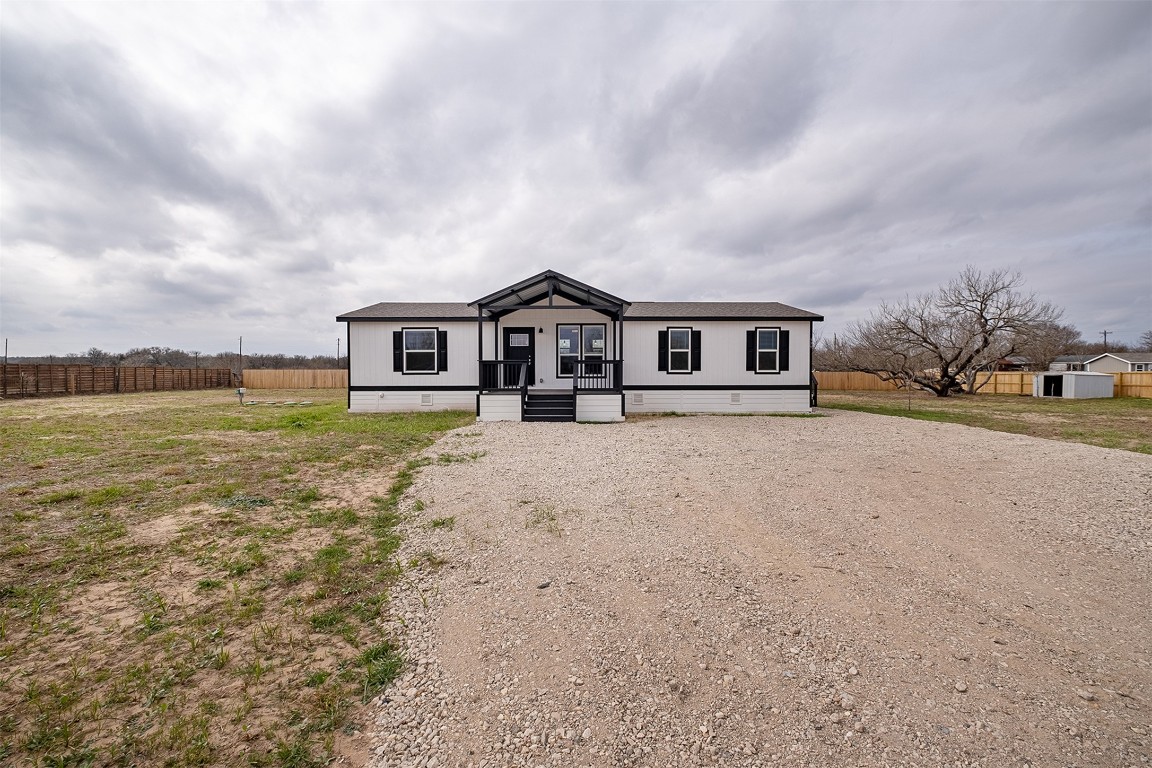 339 Lower Red Rock Road Bastrop, TX 78602 - Photo 1 of 29 a view of a house with a yard and potted plants