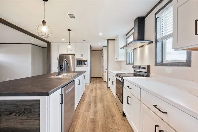 a kitchen with granite countertop a stove and a wooden floors