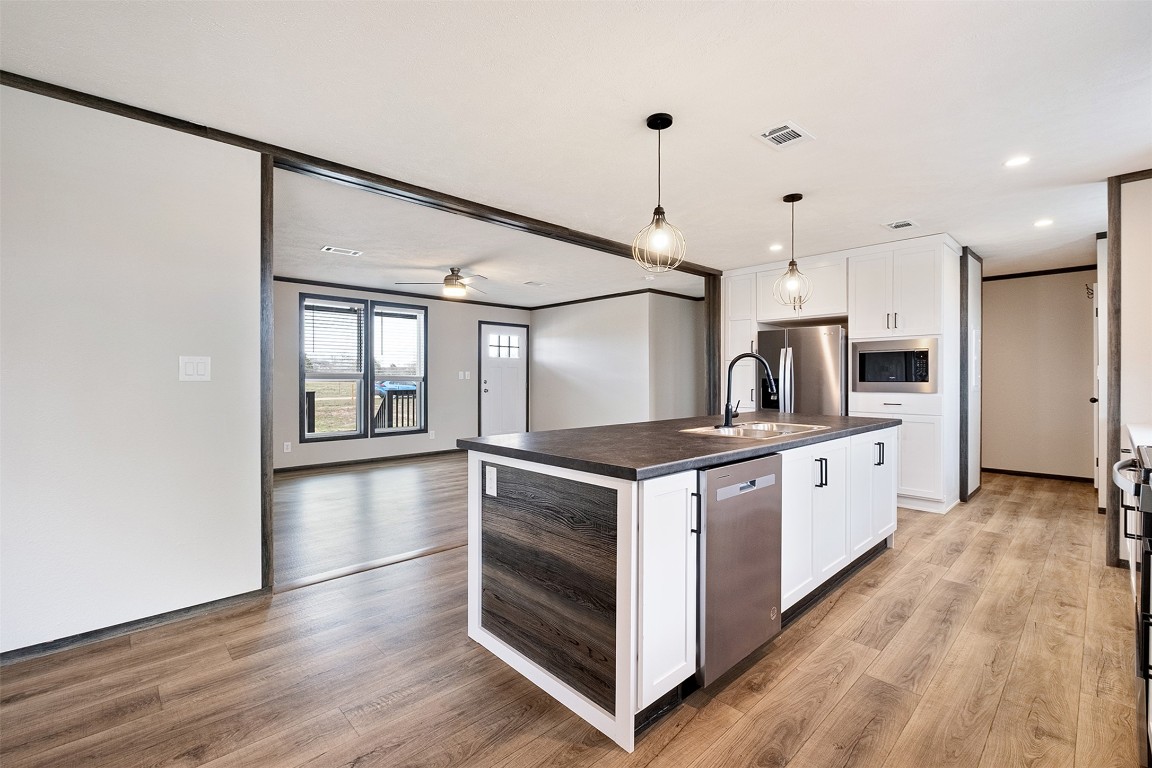 339 Lower Red Rock Road Bastrop, TX 78602 - Photo 12 of 29 a large kitchen with stainless steel appliances granite countertop a stove and a refrigerator