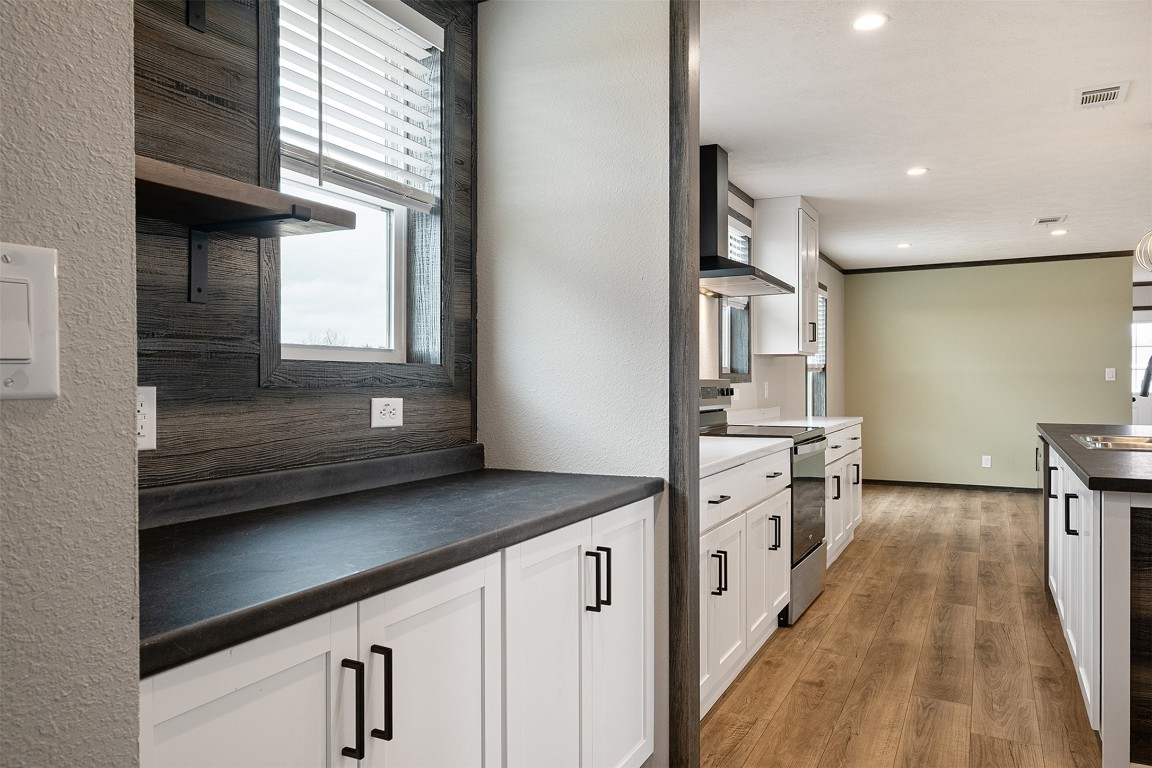 339 Lower Red Rock Road Bastrop, TX 78602 - Photo 13 of 29 a kitchen with granite countertop a sink stove and cabinets