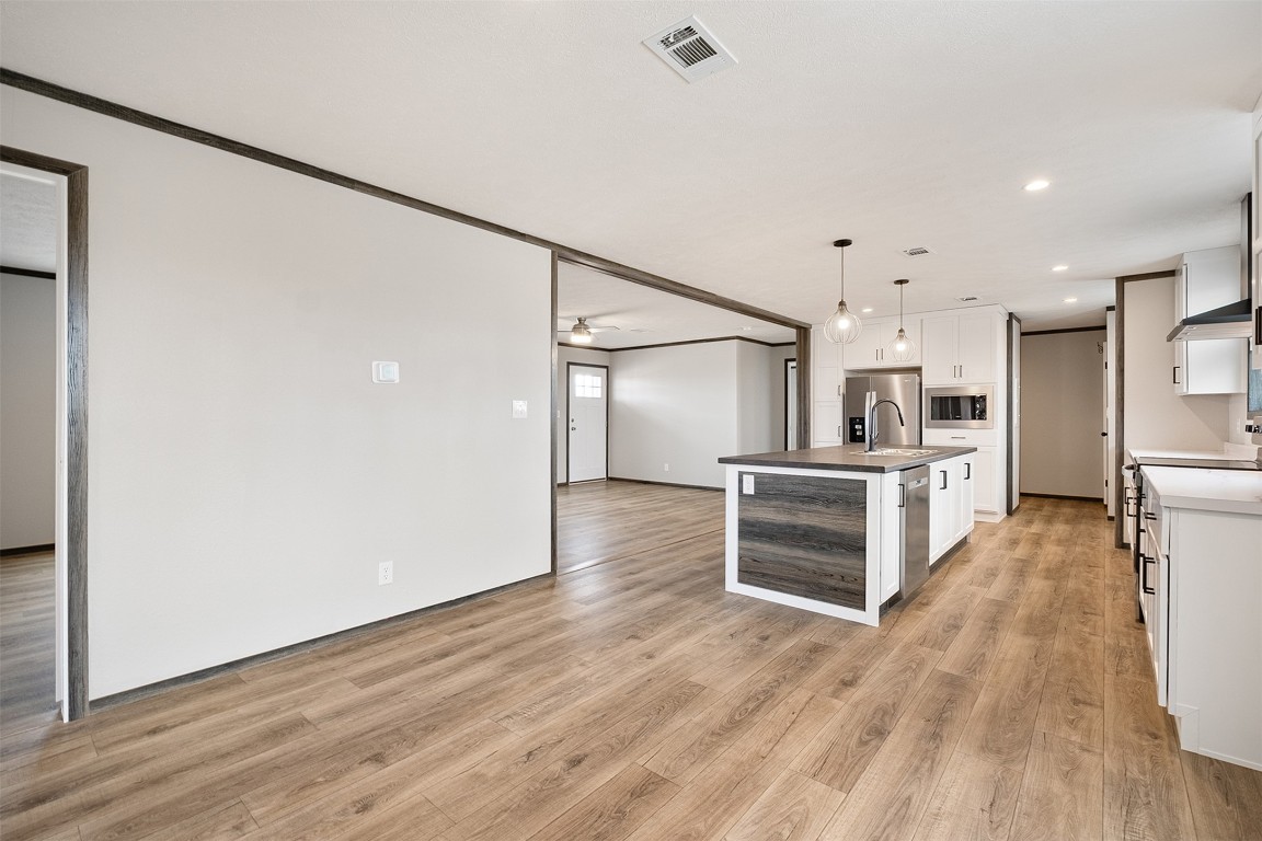 339 Lower Red Rock Road Bastrop, TX 78602 - Photo 15 of 29 a view of kitchen and wooden floor