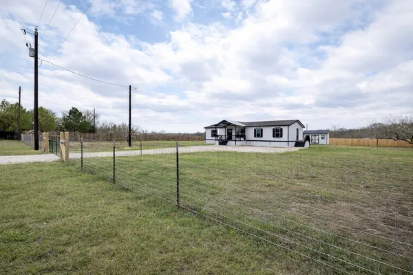 a view of a garden with tall buildings