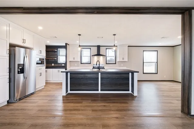 a kitchen with stainless steel appliances a stove and cabinets