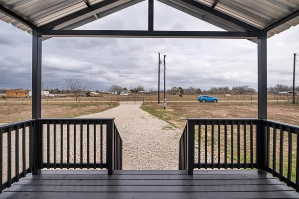 a view of a balcony with lake view and wooden floor