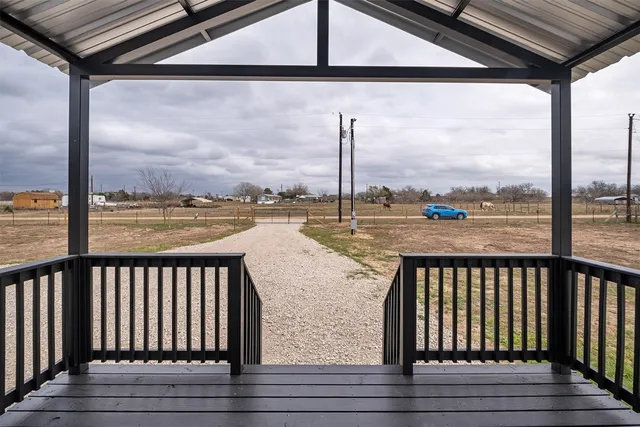 a view of a balcony with lake view and wooden floor