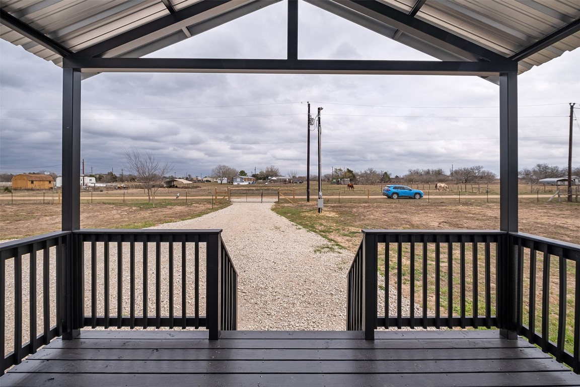 339 Lower Red Rock Road Bastrop, TX 78602 - Photo 5 of 29 a view of a balcony with lake view and wooden floor