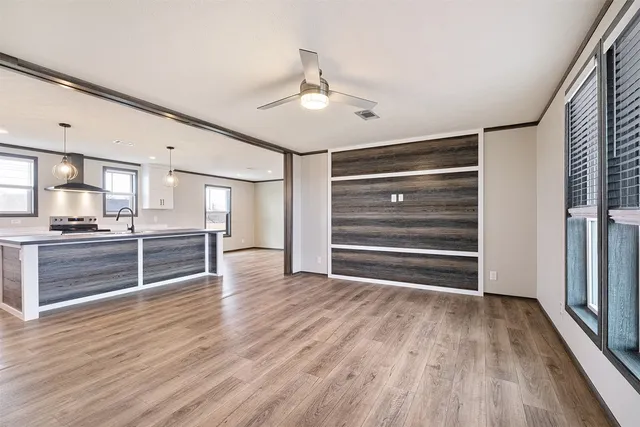 a view of kitchen with wooden floor electronic appliances and window