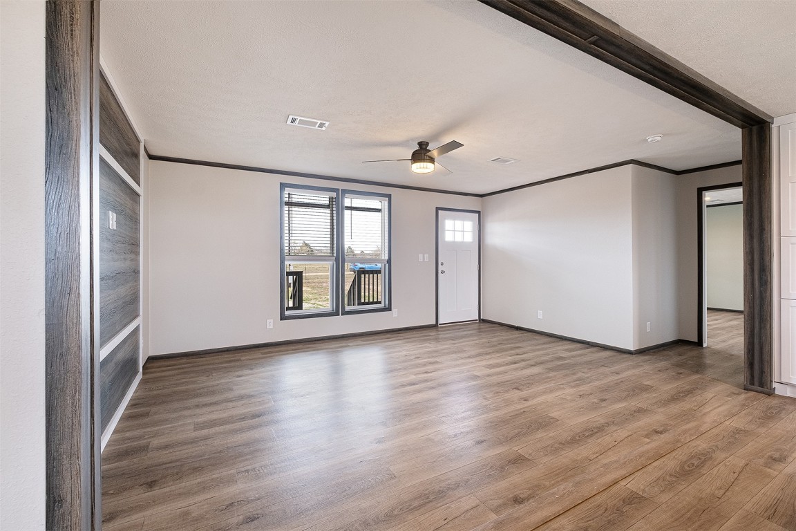 339 Lower Red Rock Road Bastrop, TX 78602 - Photo 8 of 29 a view of an empty room with wooden floor and a window