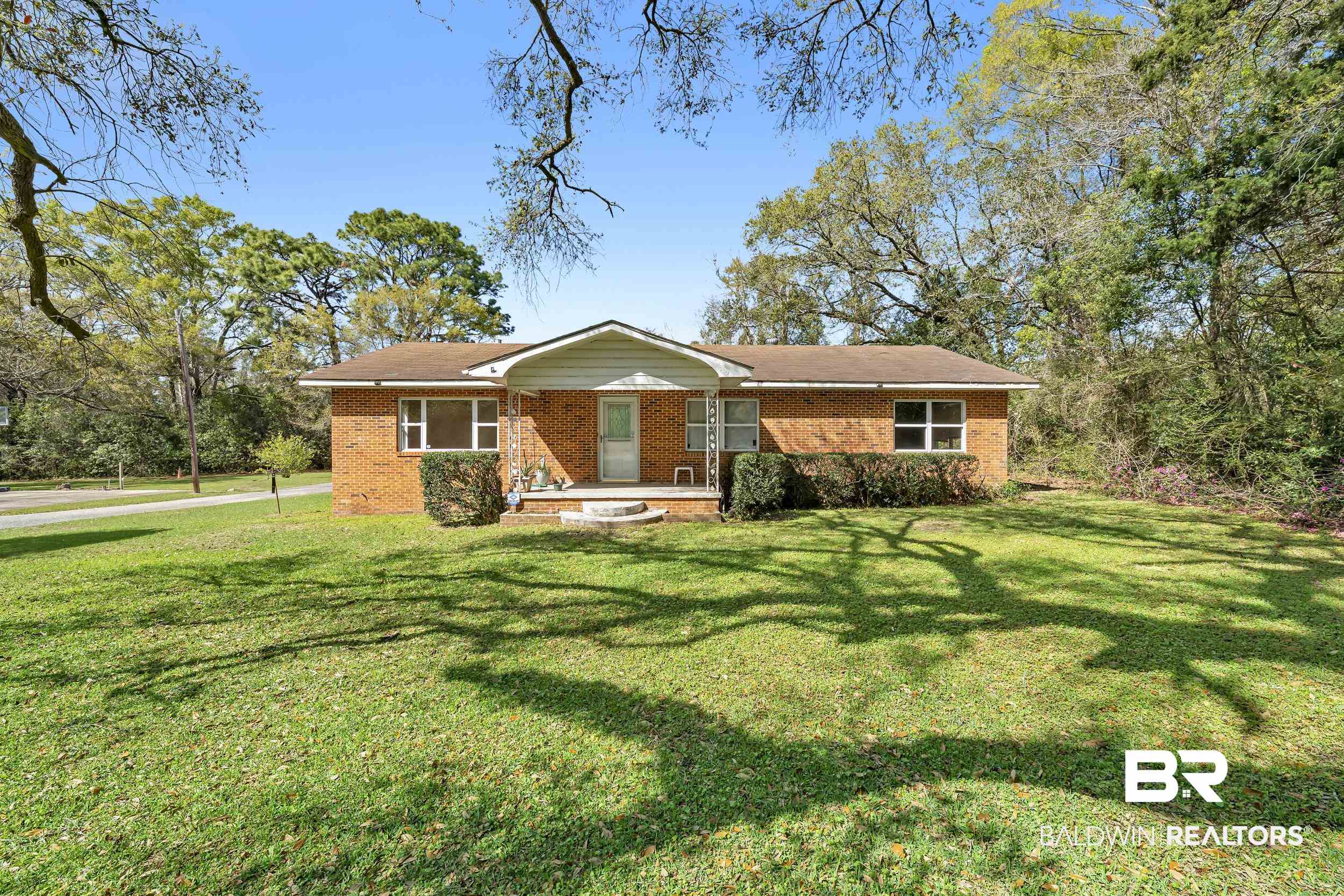 17463 Highway 98 Foley, AL 36535 - Photo 23 of 57 View of front of property featuring brick siding, a front yard, and covered porch