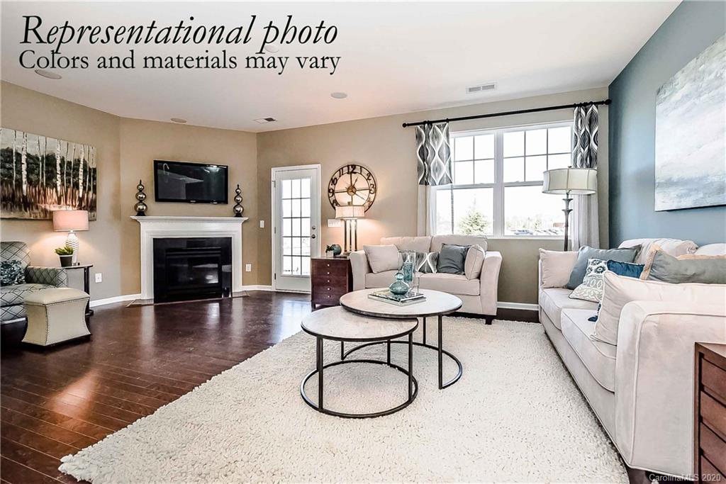 1633 Corwin Bend Road Tega Cay, SC 29708 - Photo 4 of 10 a living room with furniture a flat screen tv and a fireplace