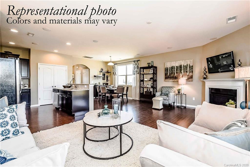 1633 Corwin Bend Road Tega Cay, SC 29708 - Photo 5 of 10 a living room with furniture a flat screen tv and kitchen view