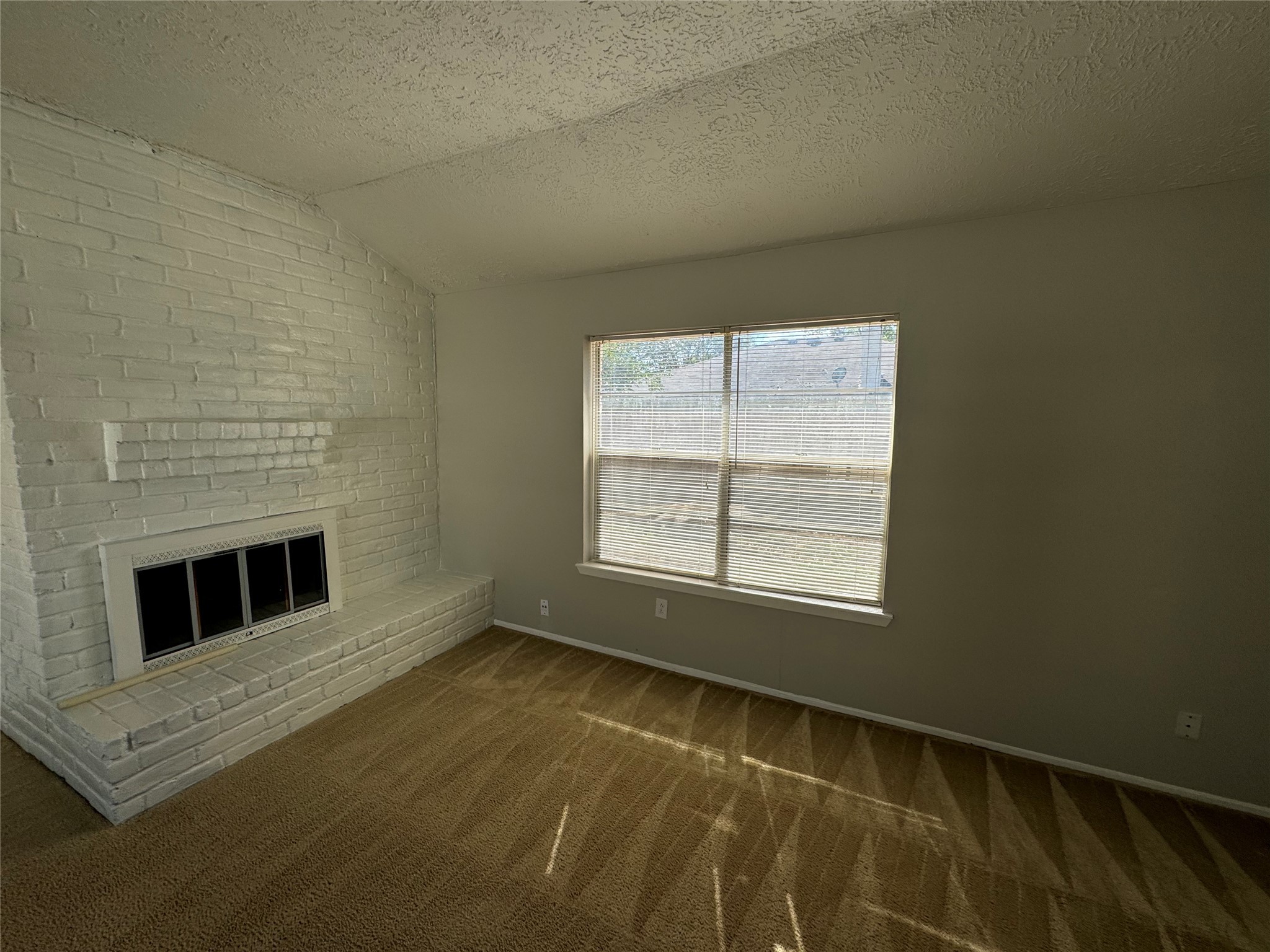 23227 Low Ridge Road Spring, TX 77373 - Photo 5 of 22 a view of an empty room with a fireplace and a window